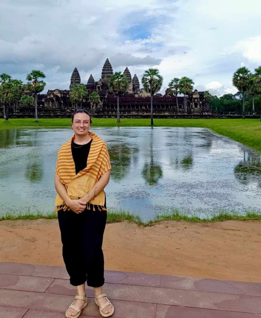 posing in front of angkor wat temple complex in siem reap